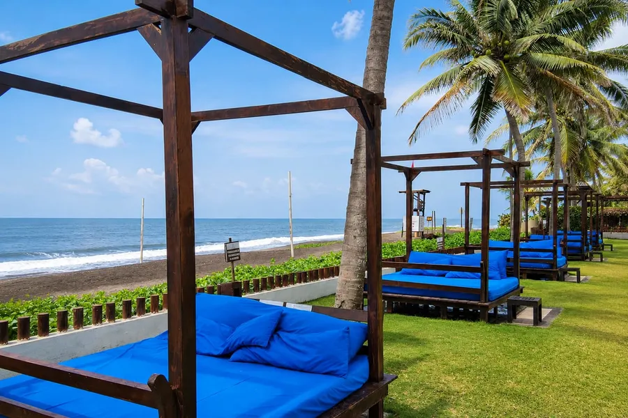 Daybeds facing Monterrico's black sand